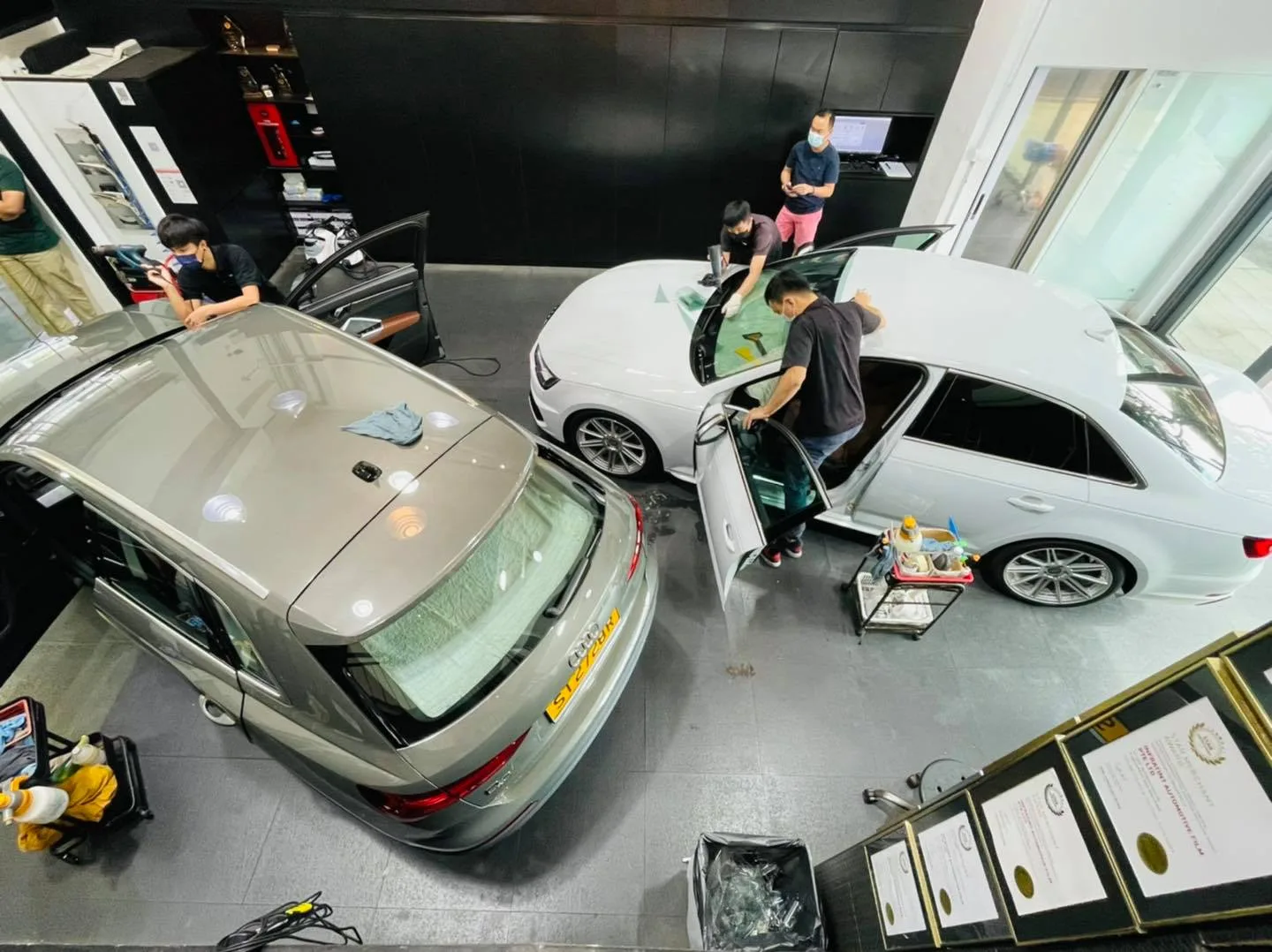 Silver Audi estate and white Audi sedan during window film install at Infratint Singapore