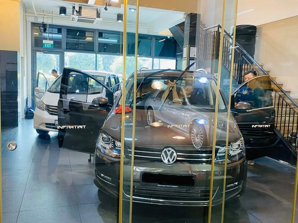 Brown Volkswagen Sharan and white Honda Freed inside Infratint Singapore
