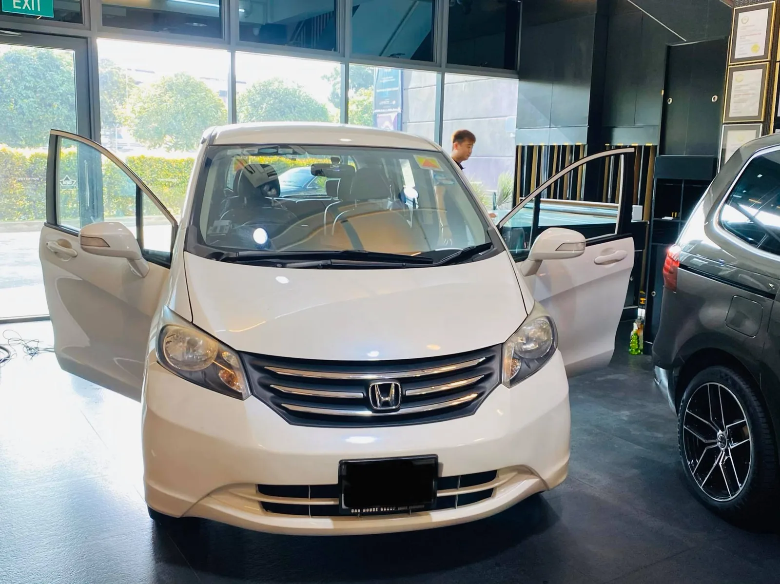 White Honda Freed MPV with front doors open at Infratint Singapore for window tinting