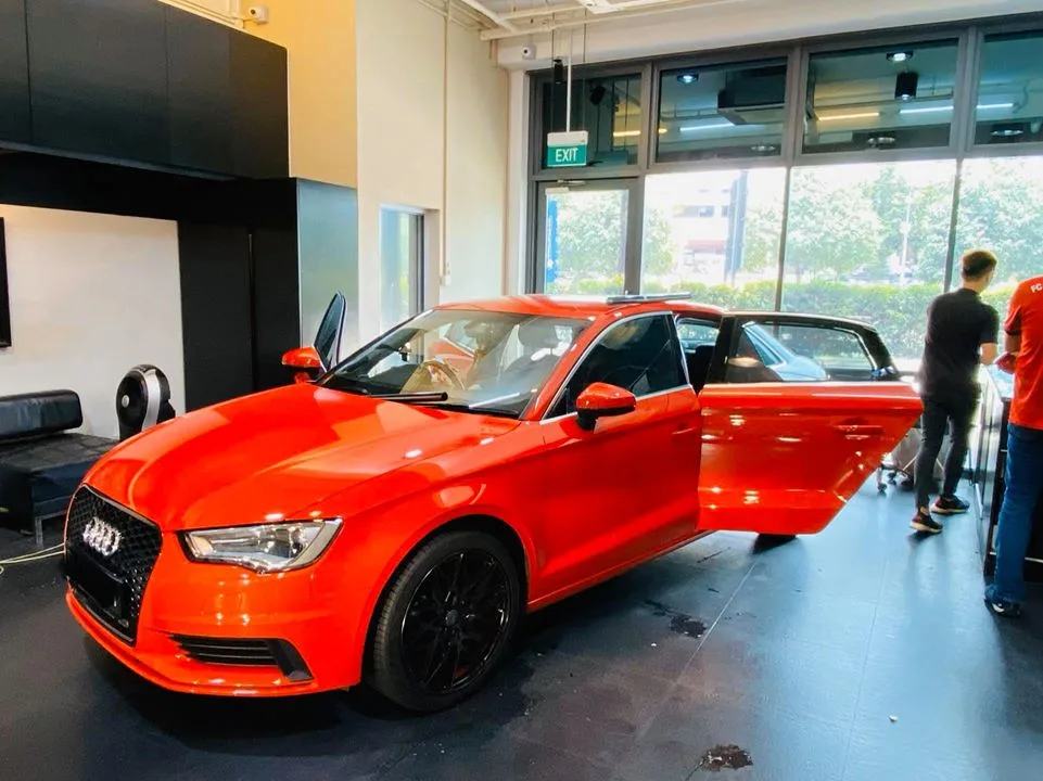 Red Audi A3 quattro being prepared for window tinting at Infratint Singapore