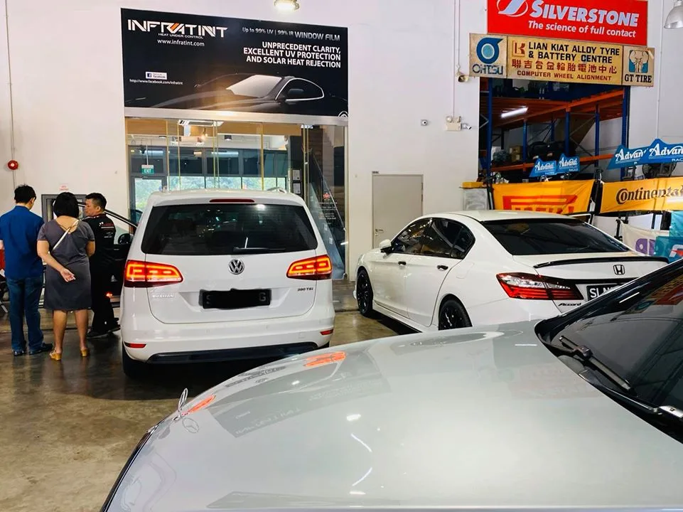 White Volkswagen Sharan and Honda Accord waiting for window tinting at Infratint Singapore