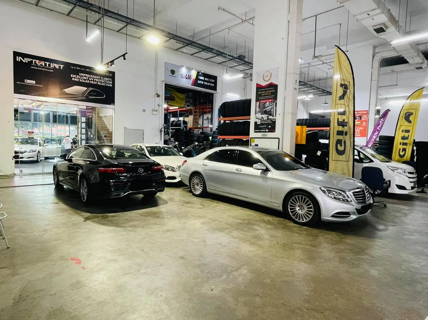 Silver Mercedes-Benz and a black sedan inside the Infratint Singapore workshop