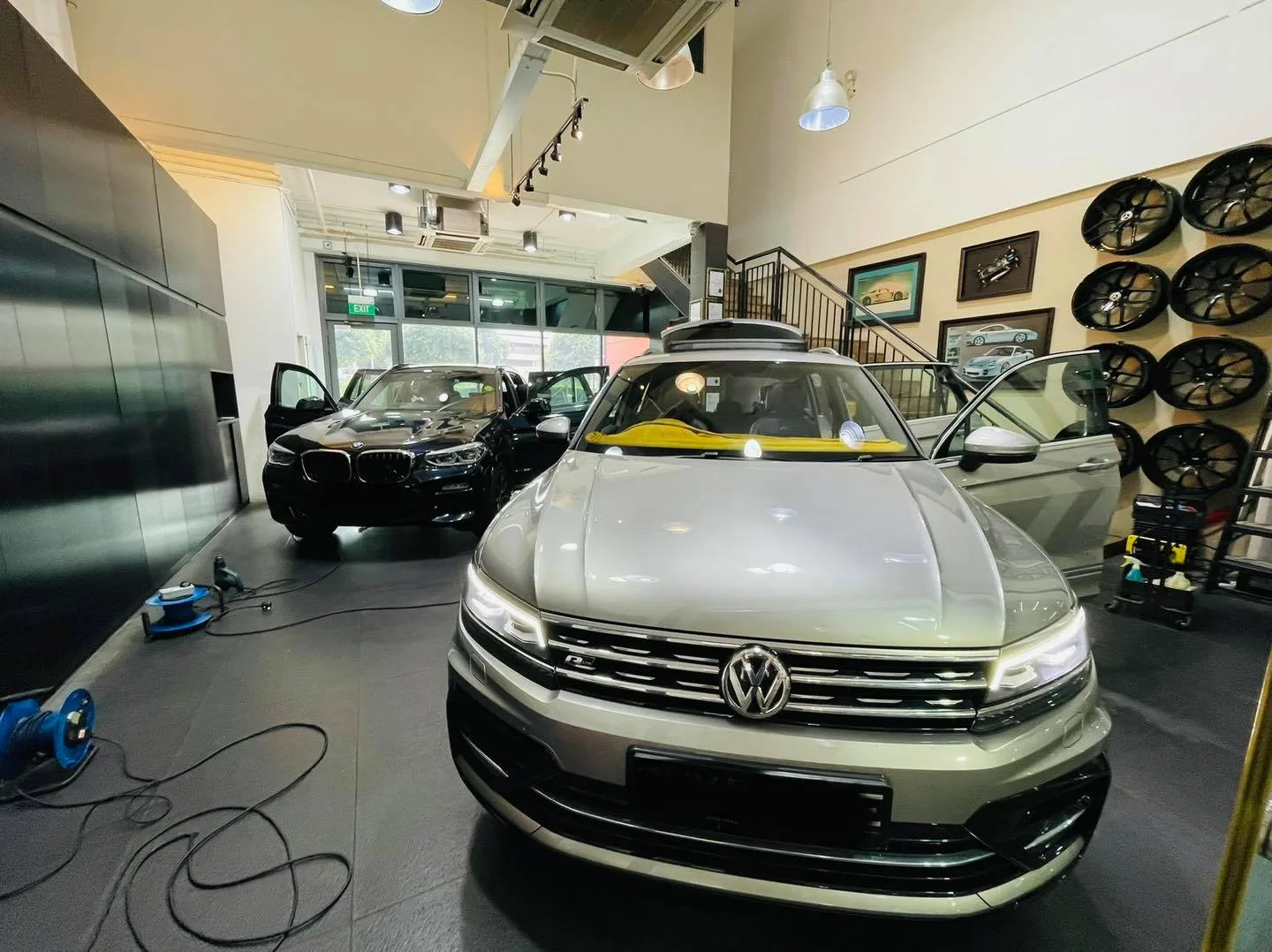 Silver Volkswagen Tiguan SUV front view at Infratint Singapore with a BMW behind