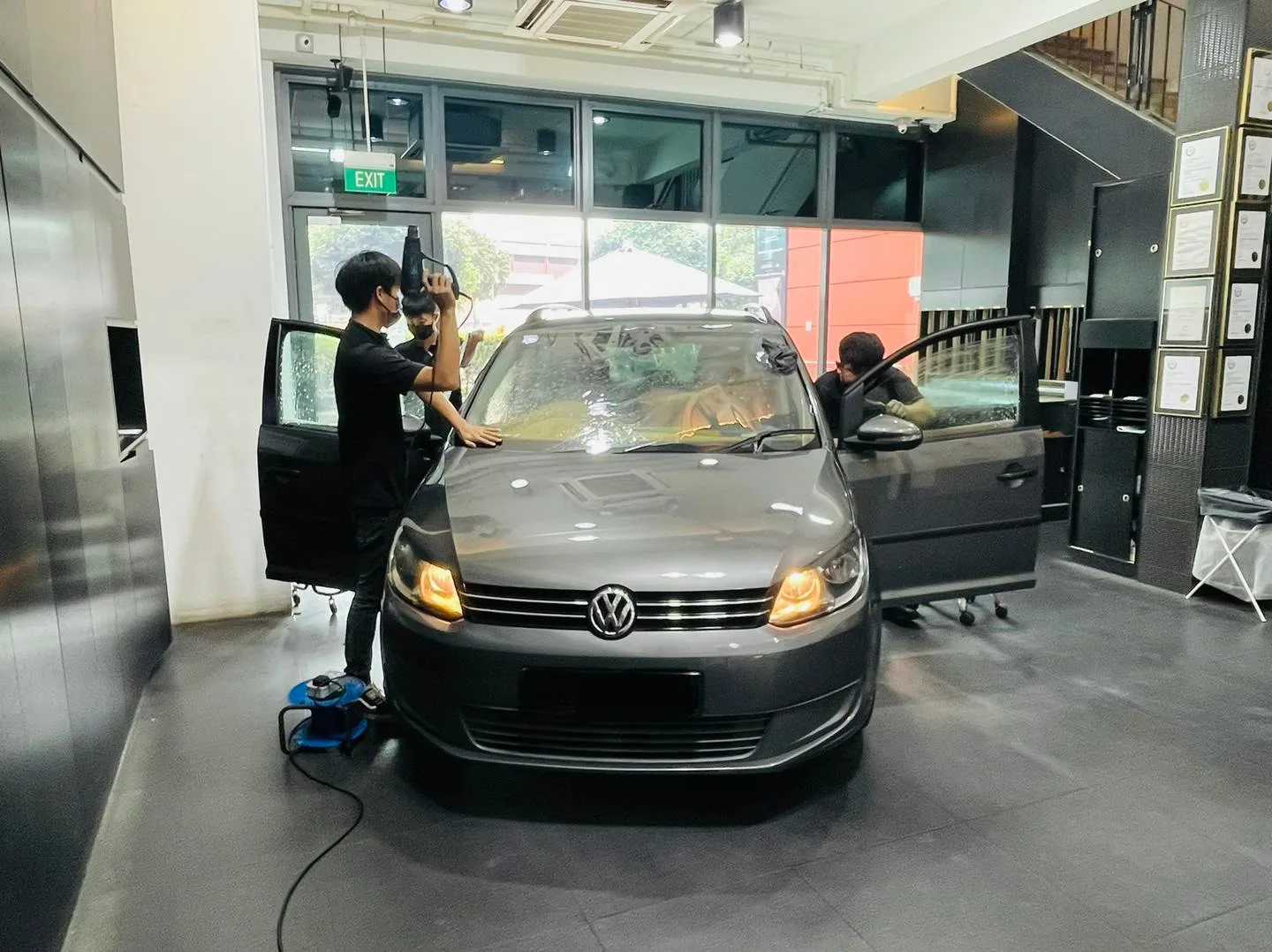 Grey Volkswagen Touran getting its windscreen tinted at Infratint Singapore