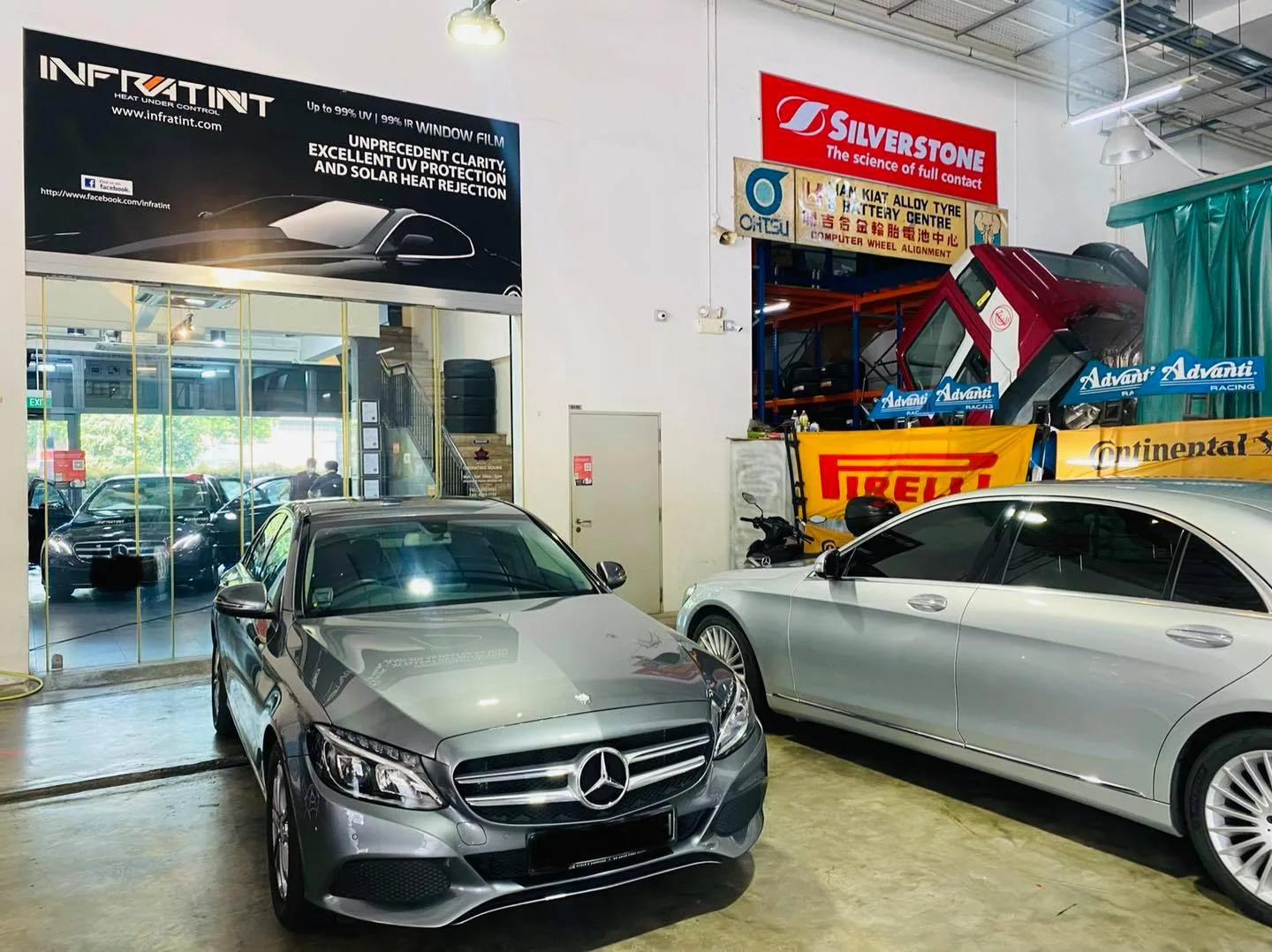 Grey Mercedes-Benz C-Class and silver Mercedes-Benz S-Class under the Infratint banner at Infratint Singapore