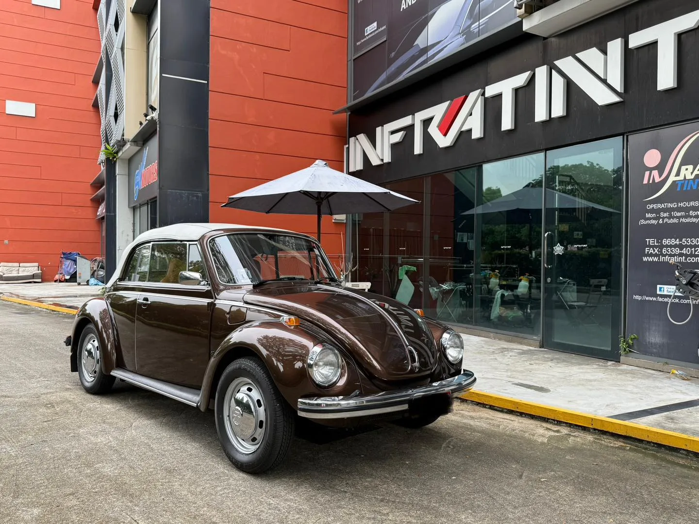 Brown Volkswagen Beetle convertible front three-quarter view outside Infratint Singapore
