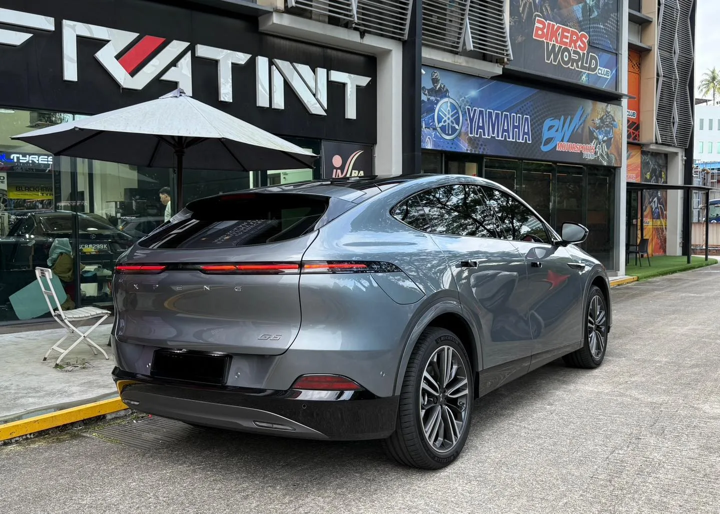Grey XPENG G6 rear three-quarter view outside Infratint Singapore