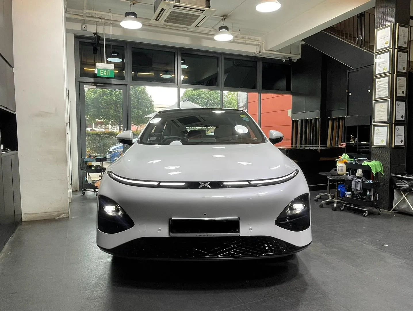 White XPENG G6 front view inside Infratint workshop