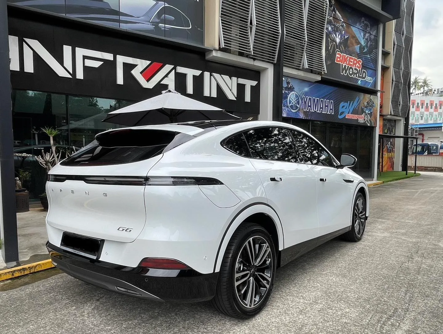 White XPENG G6 rear three-quarter view outside Infratint Singapore