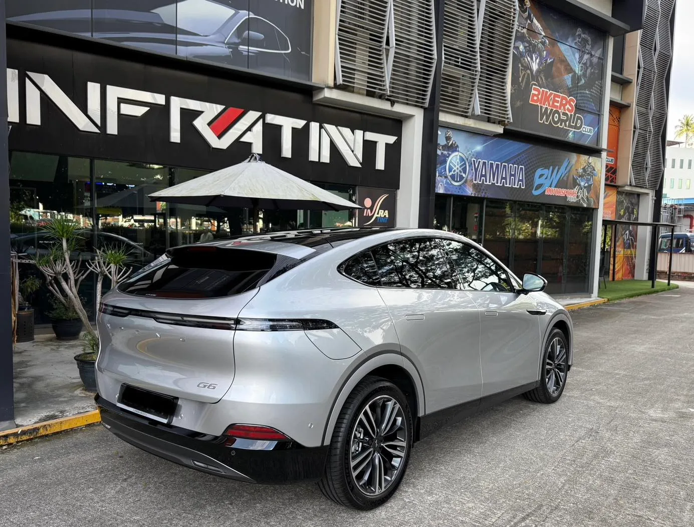 Silver XPENG G6 rear three-quarter view with tinted glass and tail light bar at Infratint Singapore