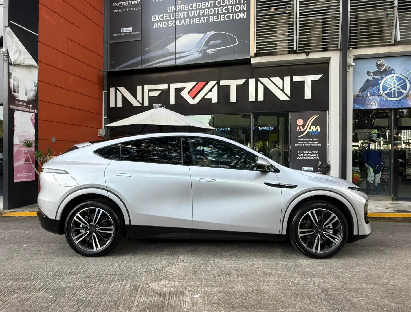 Silver XPENG G6 side profile with tinted windows outside Infratint Singapore