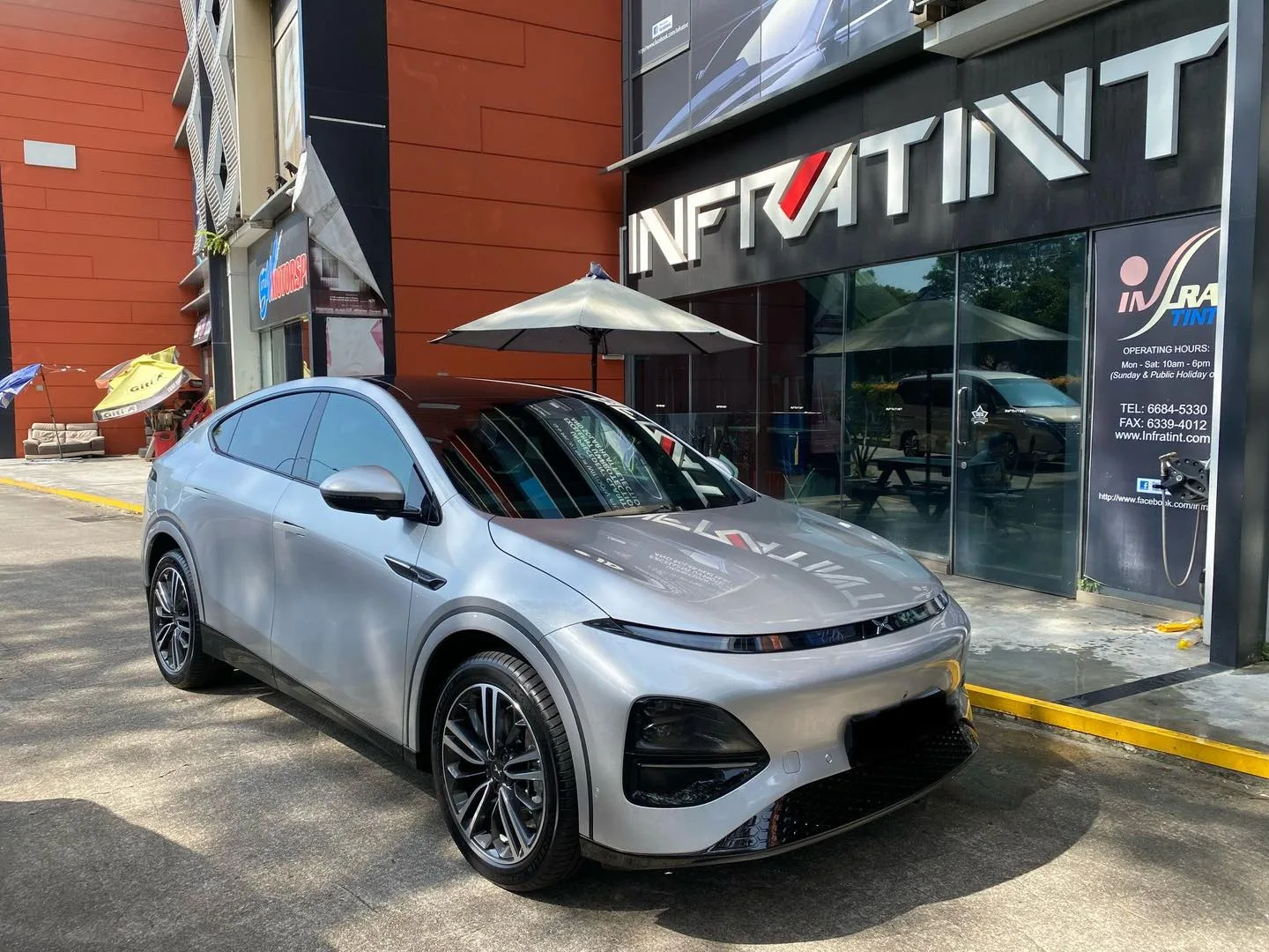 Silver XPENG G6 front three-quarter view outside Infratint Singapore