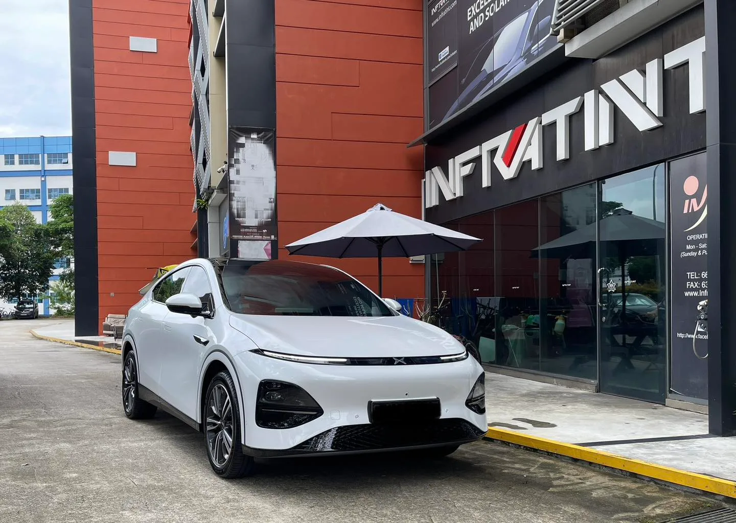 White XPENG G6 front three-quarter view with tinted glass at Infratint Singapore