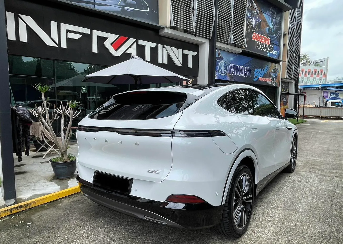 White XPENG G6 rear three-quarter view with tinted glass at Infratint Singapore
