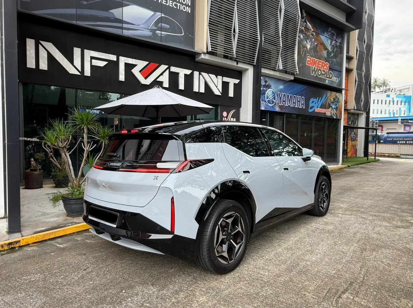 Pale grey Zeekr X rear three-quarter view outside Infratint Singapore